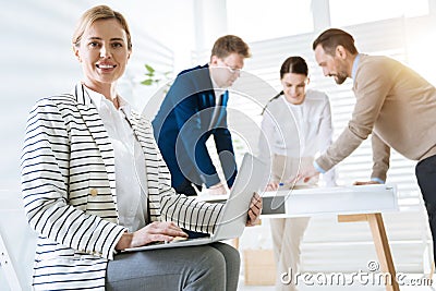 Beautiful female colleague answering online call Stock Photo