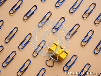 Be different, be unique concept. Staples lie on the surface. Stock Photo