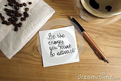 Be the energy you want to attract text handwritten on sticky note with coffee and pen Stock Photo