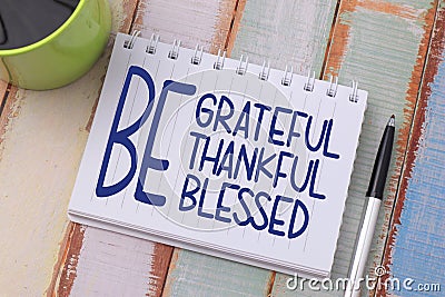 Be grateful thankful blessed, text words typography written on book against wooden background, life and business motivational Stock Photo