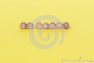 Be happy text on wooden block Stock Photo