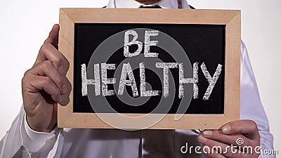 Be healthy text on blackboard in doctor hands, immune system, active lifestyle Stock Photo
