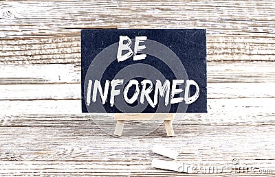 BE INFORMED text on the Miniature chalkboard on wooden background Stock Photo