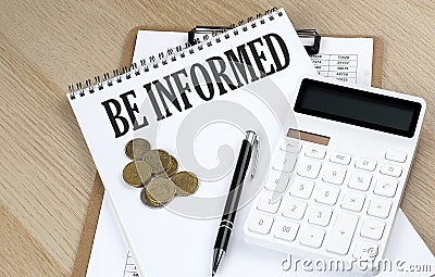 BE INFORMED text on a notebook with chart and calculator and coins, business concept Stock Photo