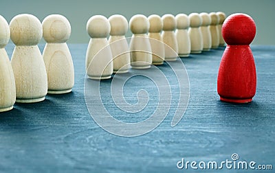 Be unique and different. Red figurine stand out from the crowd Stock Photo