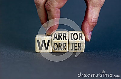 Be warrior not worrier symbol. Concept words Warrior and Worrier on wooden cubes. Businessman hand. Beautiful grey table grey Stock Photo