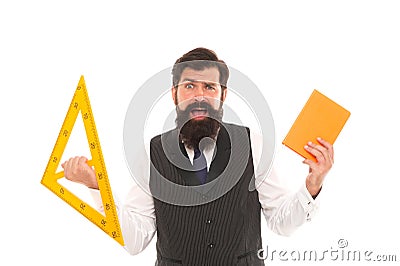 Be wise guy, give math try. Scared man back to school. Bearded man hold book and triangle. Brutal man ready for geometry Stock Photo
