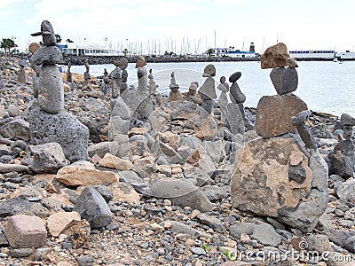 Beach art piles of rocks looking out over the bay at Playa Blanca Lanzarote Stock Photo