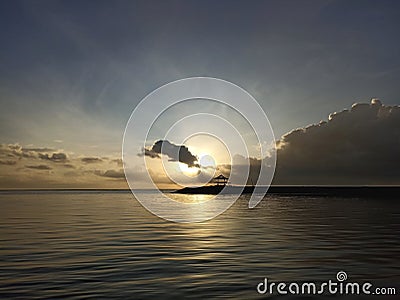Beach background with the sunrise light over the sea horizon with calm wave water. Sanur Beach morning view. Stock Photo