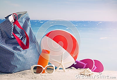 Beach bag, sun glasses and flip flops on a tropical beach Stock Photo