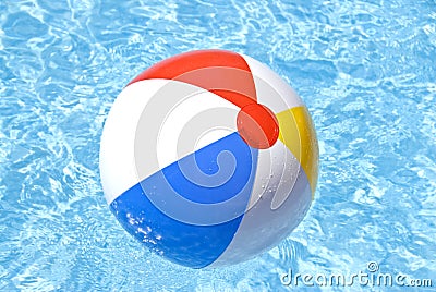 Beach Ball Floating in the Pool Stock Photo