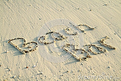 'Beach Bar' written in sand. Stock Photo