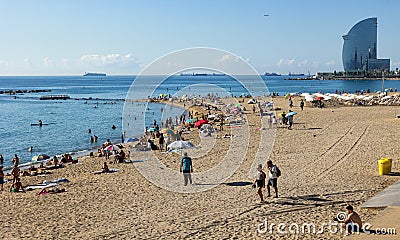 Beach of Barceloneta early morning with background huge Barcelona-W hotel Editorial Stock Photo