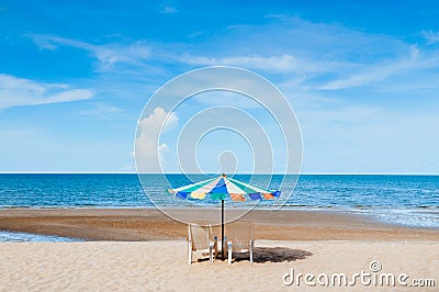 Beach beds and colourful umbrella with ocean horizon view and clear sky slightly clouds in summer Stock Photo