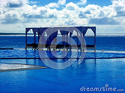 Beach beds luxury at pool looking at the carribian sea in dominican republic Stock Photo