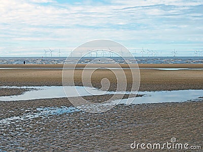 beach at blundell sands in sefton, southport with pools on the beach the beach and the wind turbines at burbo bank visible in Stock Photo