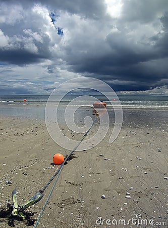 Beach boat with storm clouds Stock Photo