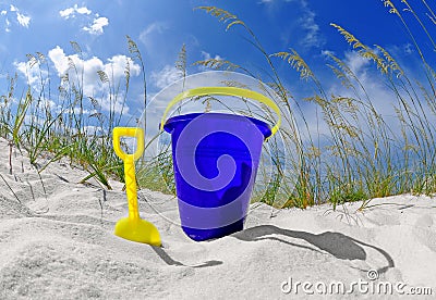 Beach bucket on sand dune Stock Photo