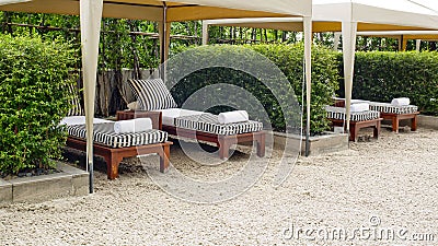 Beach chair and big umbrella on sand beach. Concept for rest, re Stock Photo