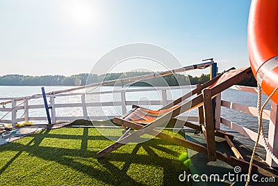 A beach chair on boat terrace for sunbathe midday Stock Photo