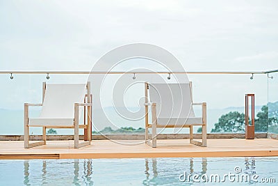 Beach chair by the pool on the rooftop hotel. Stock Photo