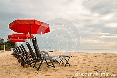 Beach chair with red umbrella on Hua Hin Beach, Phetchaburi, Thailand Stock Photo