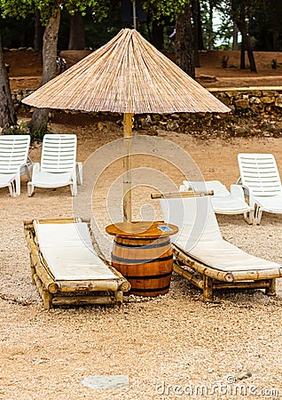 Beach chair and umbrella on sand beach. Concept for rest, relaxation, holidays, spa, resort Stock Photo