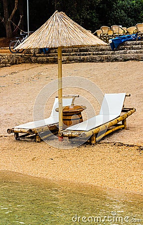 Beach chair and umbrella on sand beach. Concept for rest, relaxation, holidays, spa, resort Stock Photo