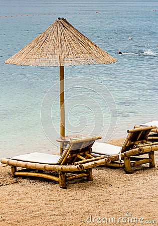 Beach chair and umbrella on sand beach. Concept for rest, relaxation, holidays, spa, resort Stock Photo