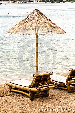 Beach chair and umbrella on sand beach. Concept for rest, relaxation, holidays, spa, resort Stock Photo