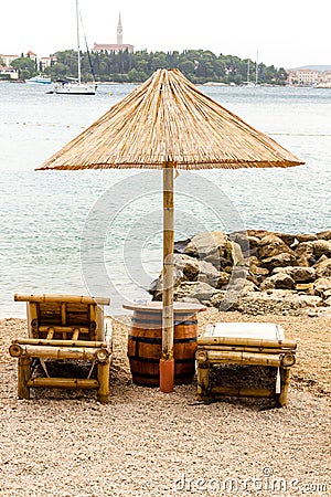 Beach chair and umbrella on sand beach. Concept for rest, relaxation, holidays, spa, resort Stock Photo