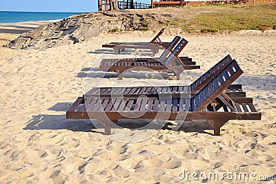 Beach chairs on sand beach. Concept for rest, relaxation, holidays, spa, resort with copy space area. Stock Photo
