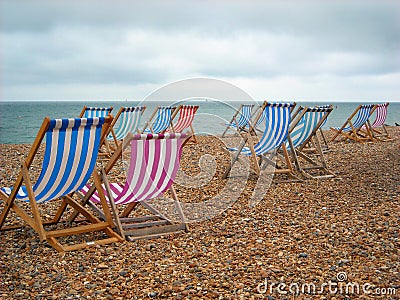 Beach Chairs on the shore at Brighton England Stock Photo