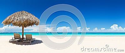 Beach chairs with umbrella and beautiful sand beach Stock Photo