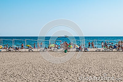 Beach coastline in the resort village of Zalizny Port. People are resting on white sand Editorial Stock Photo