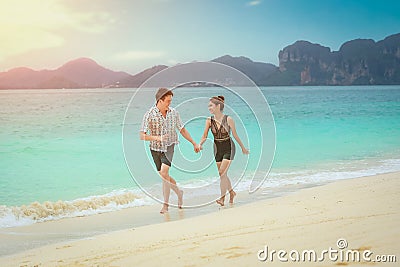 Beach couple lover walking on the beach honeymoon vacation summer holidays romance Stock Photo