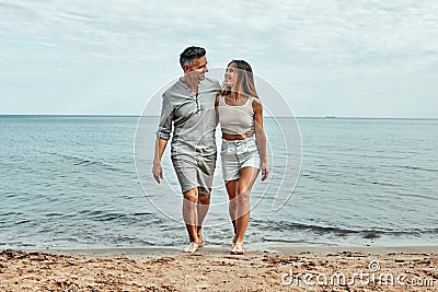 Beach couple walking on romantic travel honeymoon vacation. Summer holidays romance Stock Photo