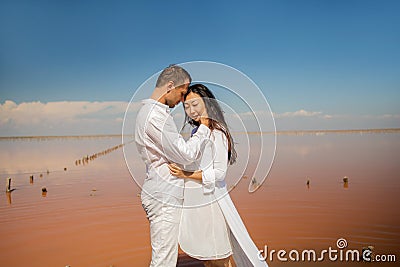 Beach couple walking on romantic travel honeymoon vacation summer vacation romance. Stock Photo