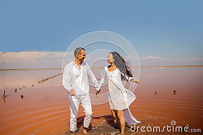 Beach couple walking on romantic travel honeymoon vacation summer vacation romance. Stock Photo