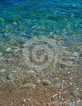 Beach. Crystal clear sea water and sand Stock Photo