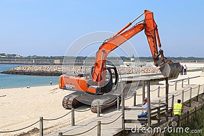 Beach erosion excavator maintenance Editorial Stock Photo