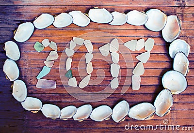 Beach glass inscription 2017 on wooden background. Stock Photo