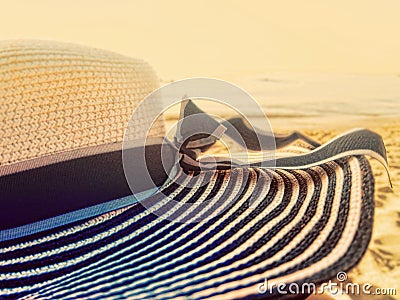 Beach hat wide large brim on a beach at sunset Stock Photo