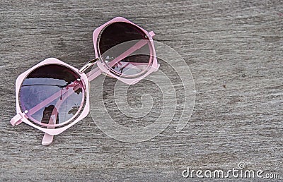 Beach holiday concept - close up pink cute women sunglasses on table Stock Photo