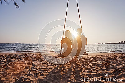 Beach holidays for romantic young couple, honeymoon vacations, silhouettes of man and woman Stock Photo