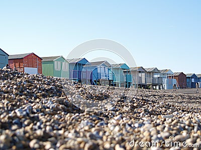 Beach Huts on pebble beach Stock Photo