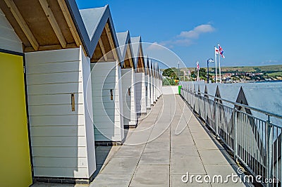 Swanage colourful Beach Huts in a Row Stock Photo