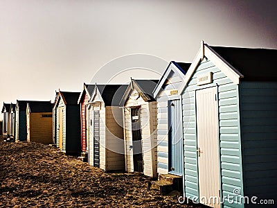 Beach huts on the sand on a cold winter day Stock Photo