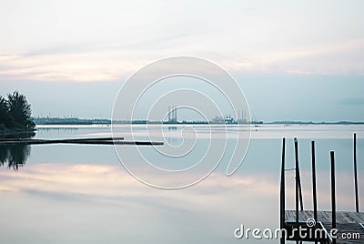 Beach landscape view with wooden foot bridge during sunset. Beatiful screnery of a beach with ocean and sky and water reflection Stock Photo