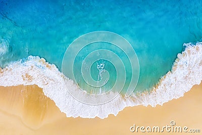 Beach and large ocean waves. Coast as a background from top view. Blue water background from drone. Summer seascape from air. Stock Photo